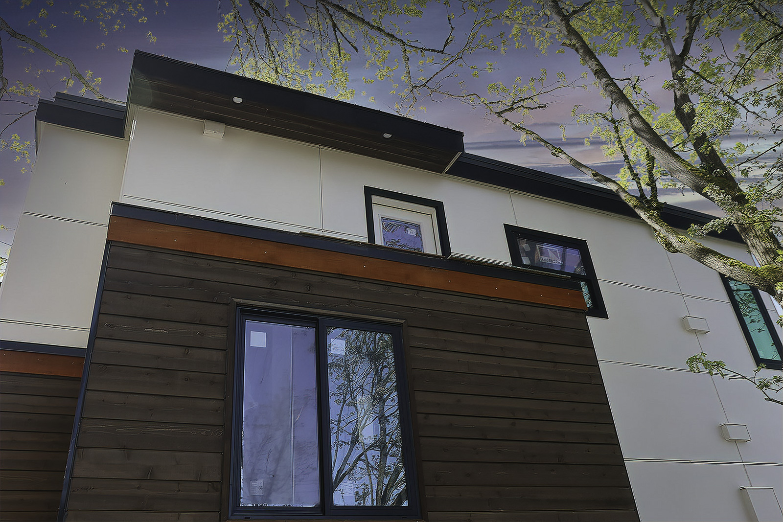 Modern residential siding with clean black trim details by Breeze Siding