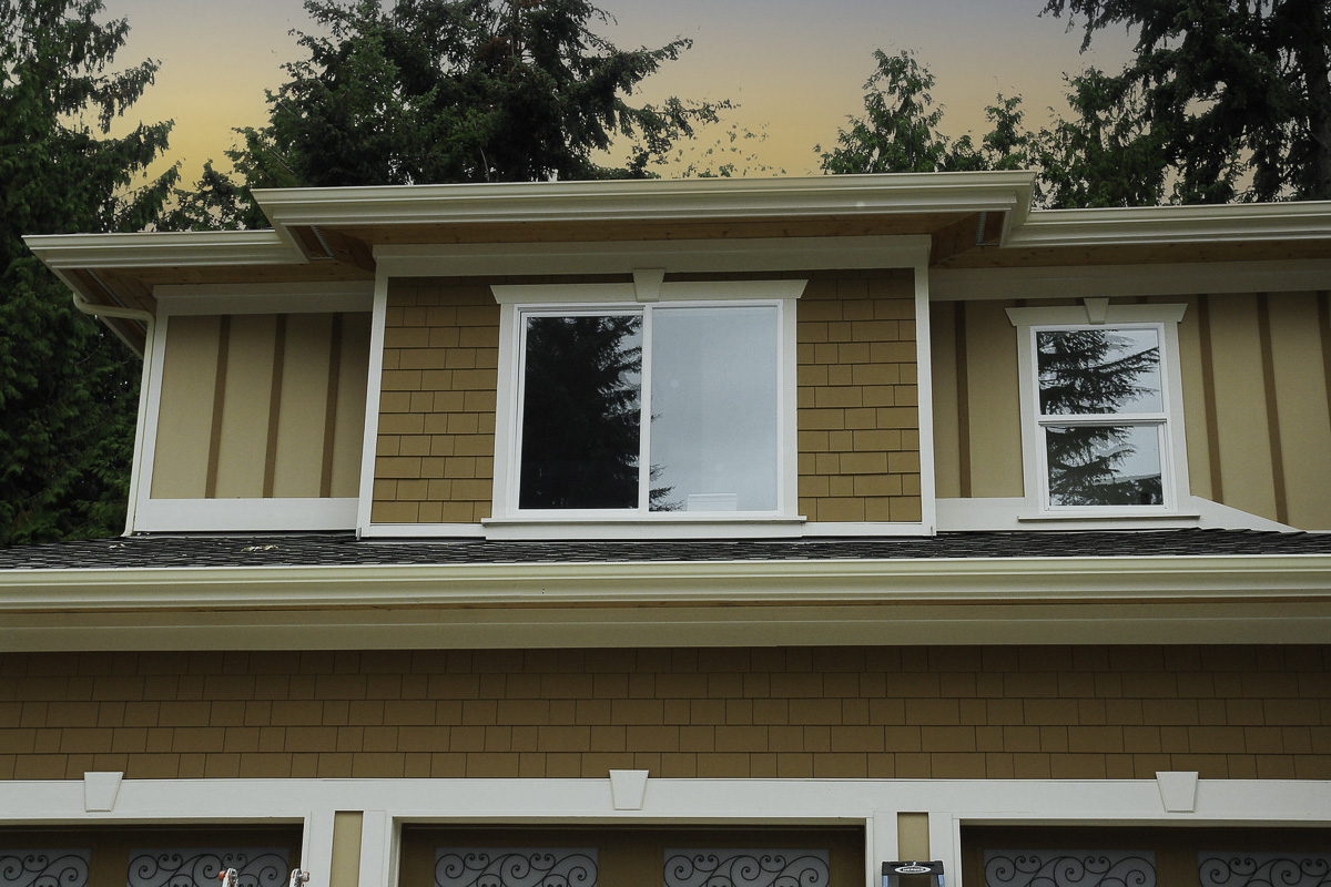Crisp trim and shingle siding detail on a high-end exterior