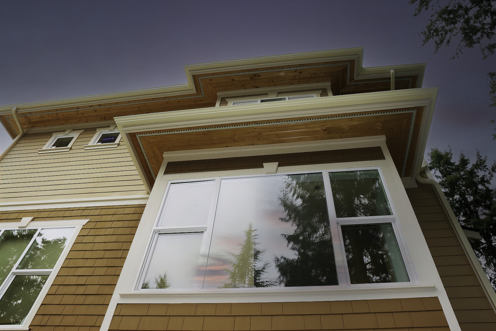 Wood siding exterior with large black windows