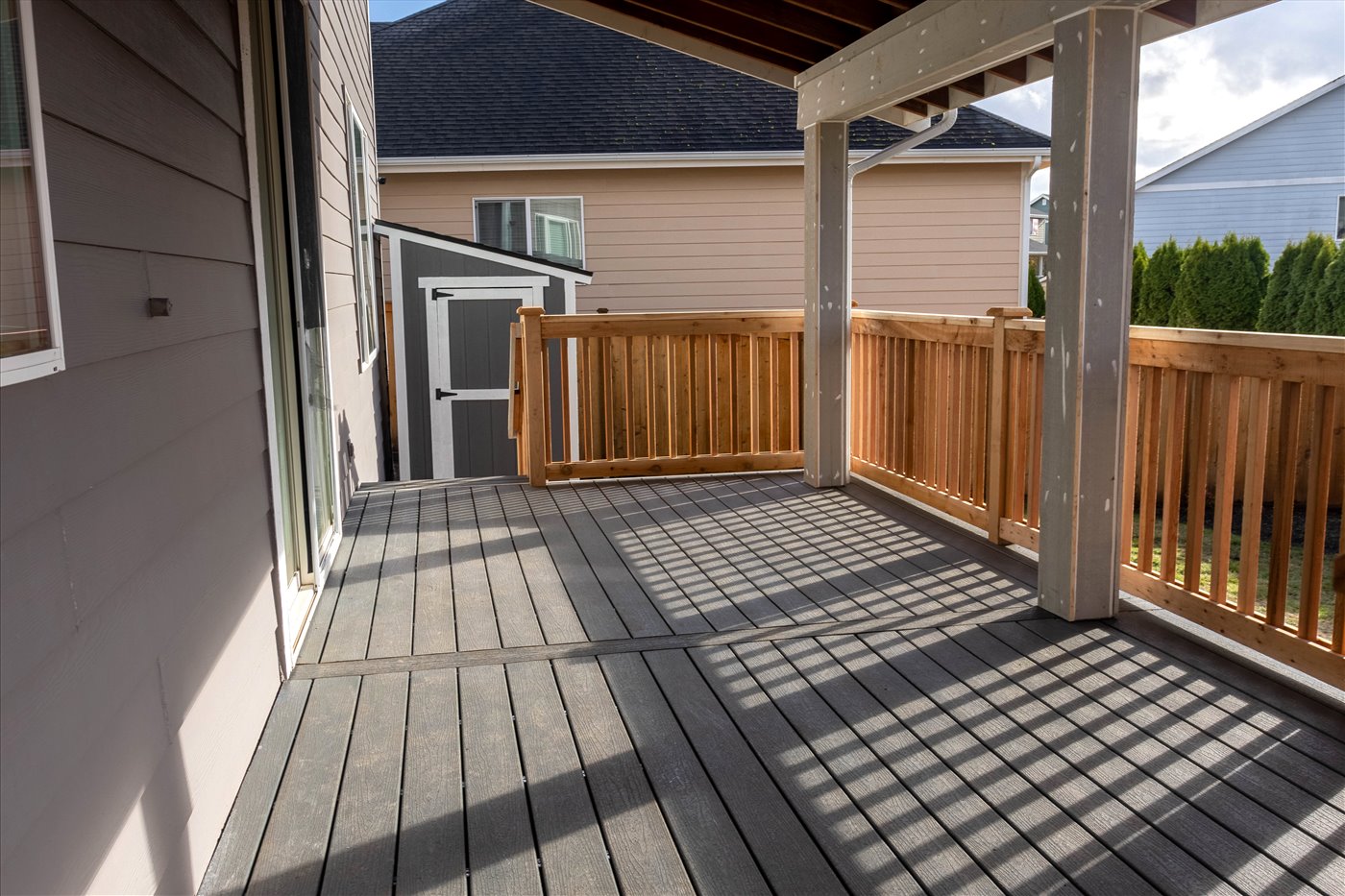 Covered deck and patio renovation with wood railing