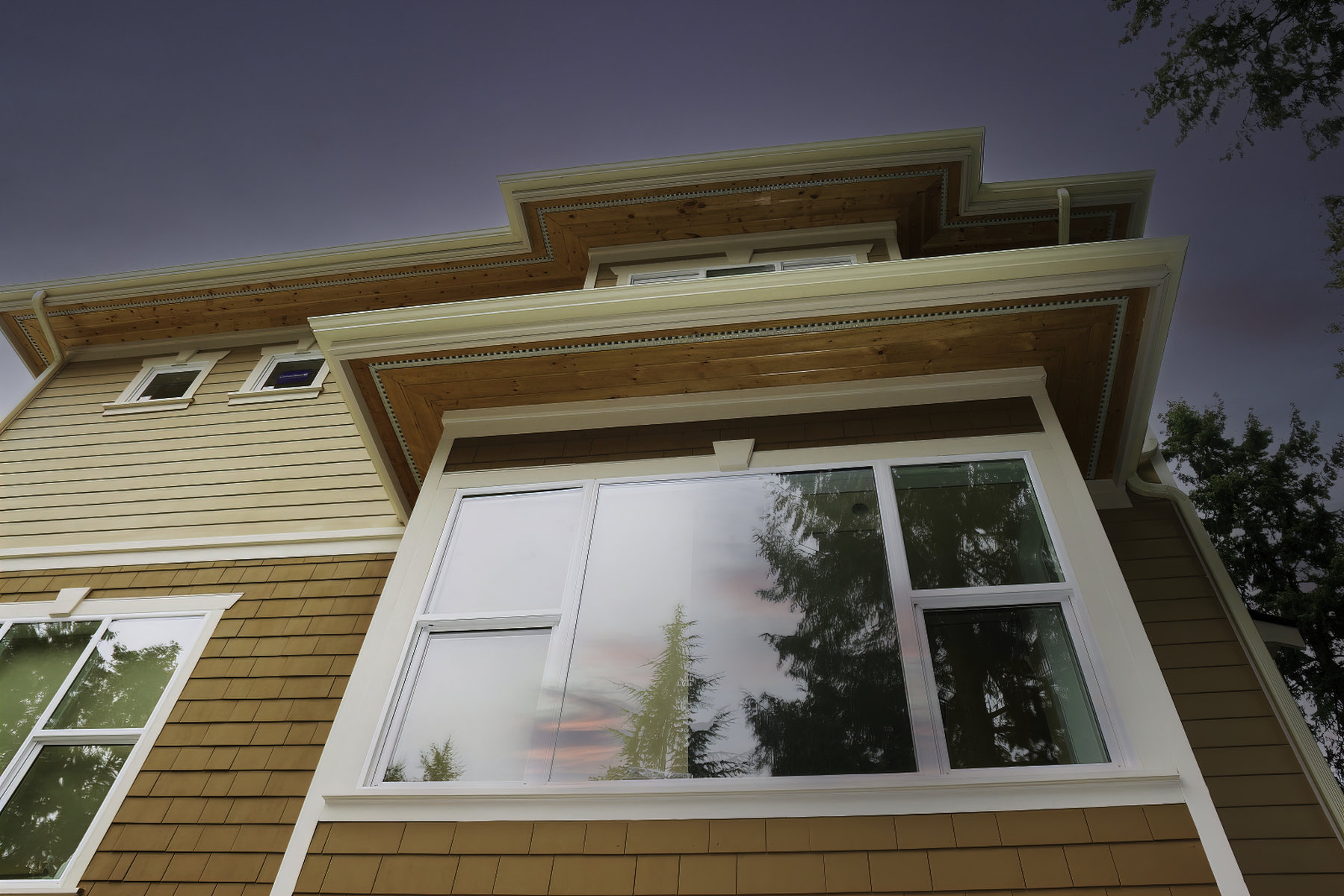 Wood siding exterior with large black windows