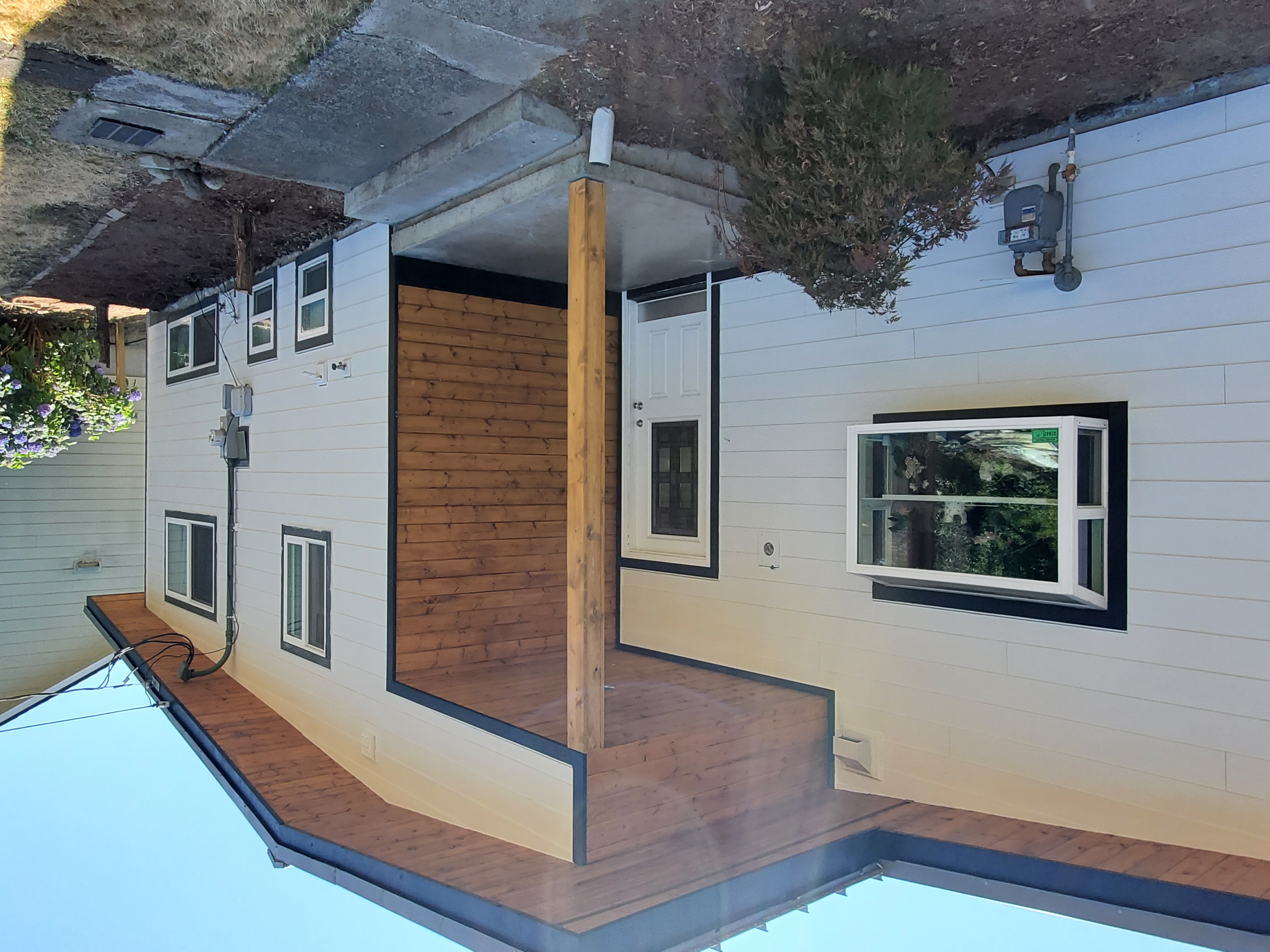 Residential siding with covered entry and wood accent detail by Breeze Siding