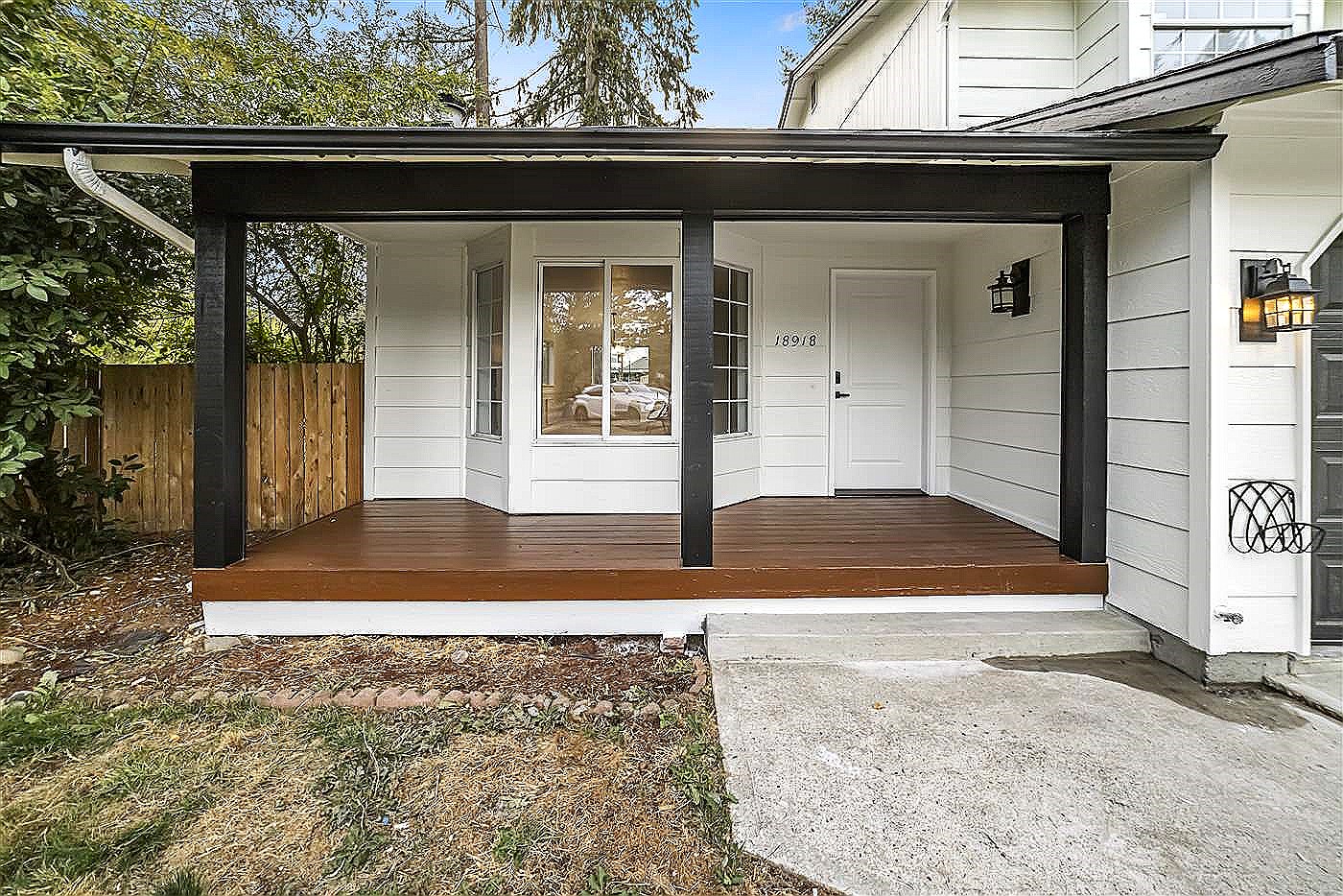 Finished exterior with fresh siding and a covered entry